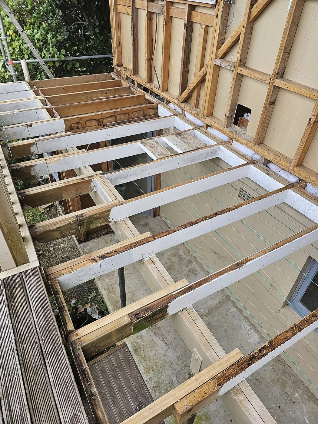 Timber framing exposed during sequenced deconstruction of a villa