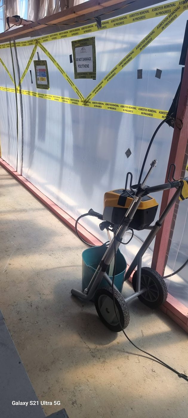 HEPA vacuum at the enclosure entry