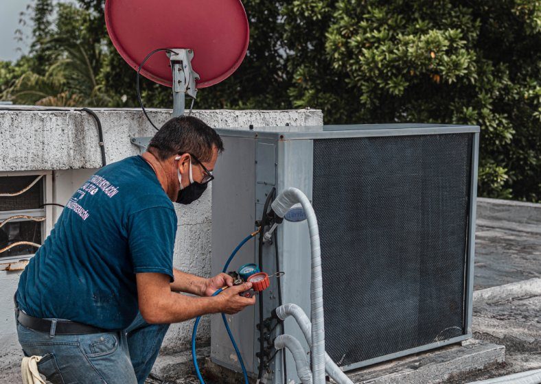 SES Property Maintenance technician carrying out repairs at an occupied Auckland commercial site