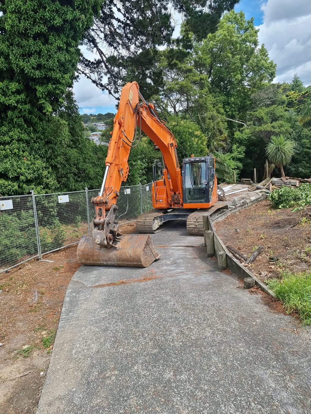 SES demolition excavator on a fenced residential site in Auckland